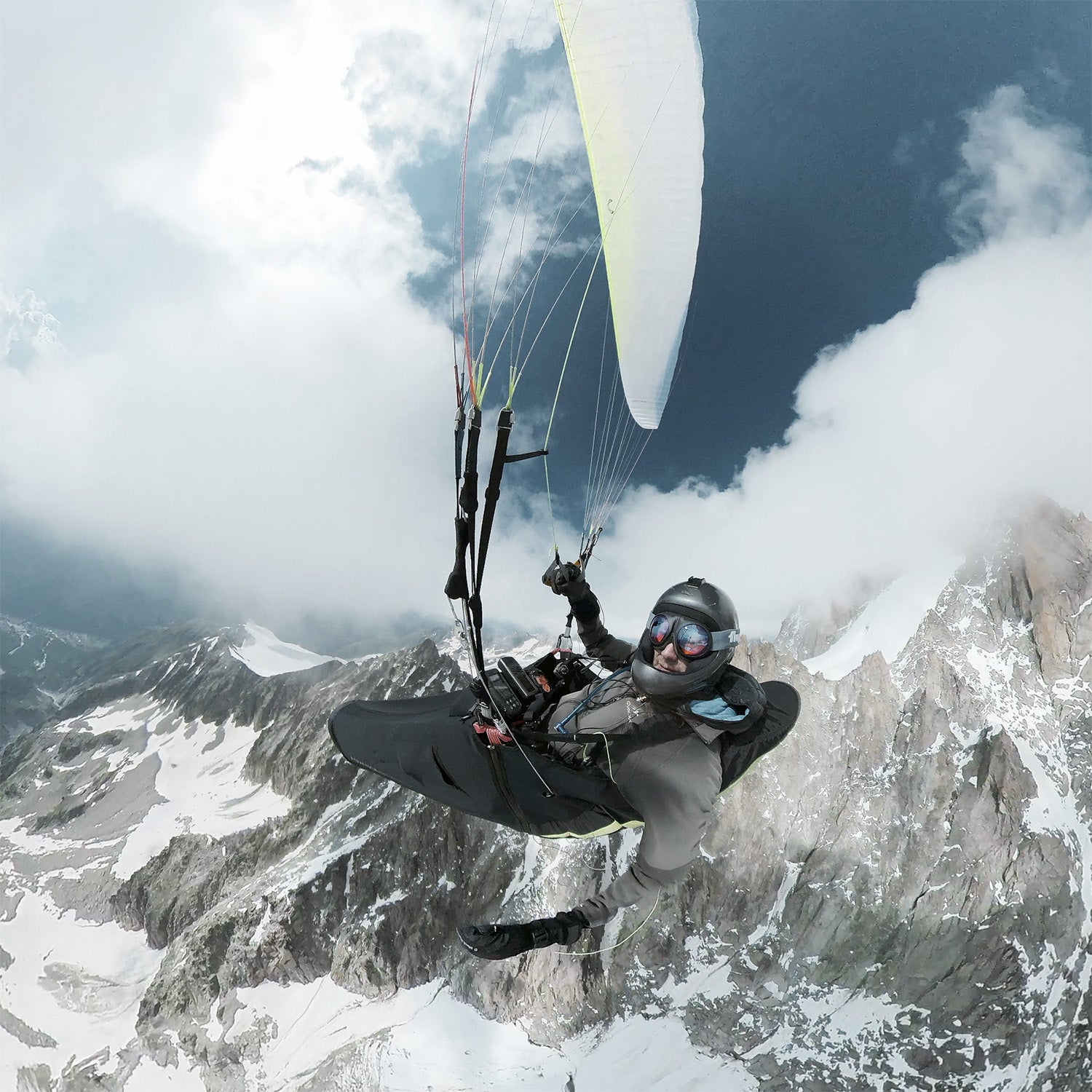 Paraglider pilot above the Alps. Fluga Sports paragliding goggles. Chamonix, France.